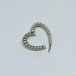 Silver pendant in the form of a heart with white zircons