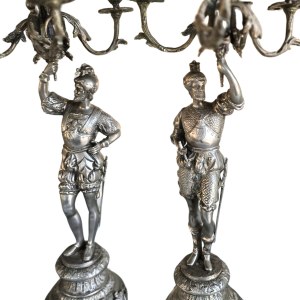 Pair of candlesticks with conquistadors