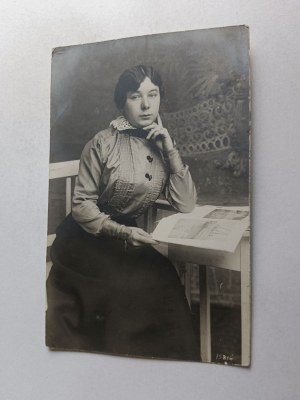 WOMAN AT A TABLE READING A GAETA