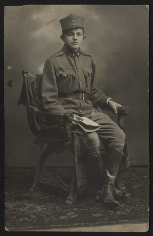 Polish Legions] Portrait photograph of a young soldier of the 3rd Brigade of the Polish Legions sitting in an armchair.