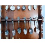 Set of collectible spoons in a wooden display case