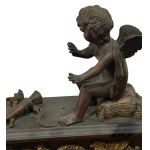 Pair of patinated bronze fireplace andirons depicting putti