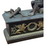 Pair of patinated bronze fireplace andirons depicting putti