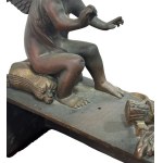Pair of patinated bronze fireplace andirons depicting putti