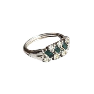 Silver (?) ring with green eyes and zircons