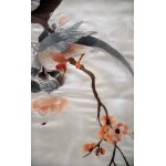 Bird on a plum tree branch