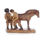 Wooden sculpture: shoeing a horse