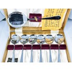 Set of chrome spoons in a box