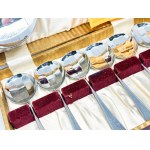 Set of chrome spoons in a box