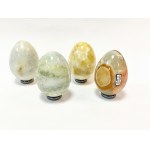 Four eggs made of crystals on saucers