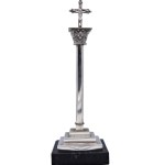 Silver crucifix on a marble base