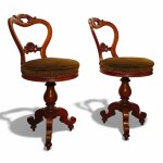 Pair of carved mahogany music chairs.