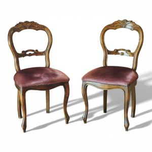 Two Louis Philippe style chairs in walnut, covered in burgundy velvet