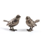 A pair of solid silver birds