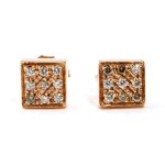 A pair of geometric gold and diamond earrings