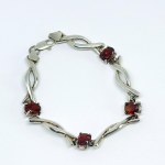 Silver bracelet with red stones
