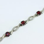 Silver bracelet with red stones