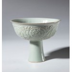 A Qingbai ceramic stemmed cup decorated with a floral motif and a celadon glaze. China, Song Dynasty (960-1269).
