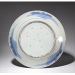A large blue and white porcelain plate in the Imari style depicting a natural landscape. Japan, late 19th-20th century.
