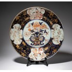 Large plate painted with coral red, blue, and gold enamels. Japan, 18th century.