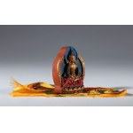 A small painted clay Tza Tza wrapped in a piece of silk fabric for daily Buddhist worship. Tibet or Nepal, 20th century.