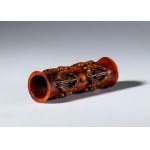 A tubular bone pendant carved with vajra-shaped elements. Tibet, 19th century