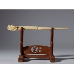 A carved elephant ivory pipe in the shape of a dragon