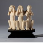 A small elephant ivory sculpture on a wooden base depicting the three monkeys Mizaru, Kikazaru, and Iwazaru. Japan, 19th century.