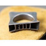 A large modernist style ring.