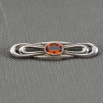 Art Deco brooch with amber glass.