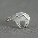 Silver bear brooch.