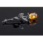 Rose brooch with amber.