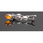 Rose brooch with amber.