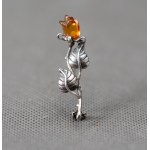 Rose brooch with amber.