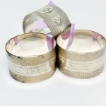 Three silver-plated napkins