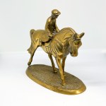 Brass statue depicting a rider on a horse